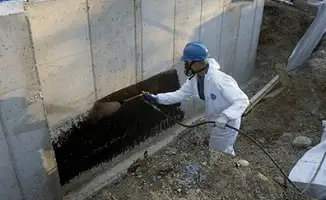 Professional waterproofing the exterior walls of the basement in Fresno, CA